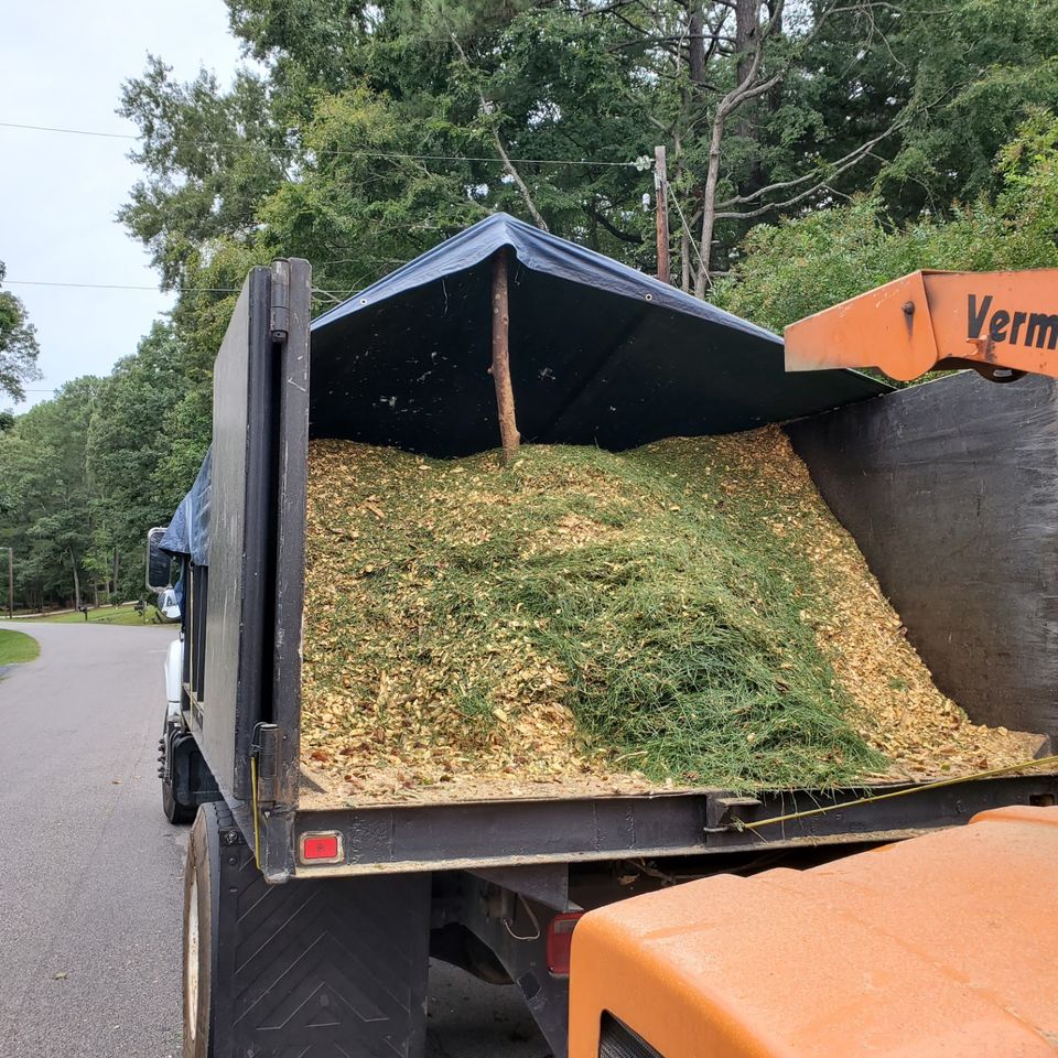 Wood chipping truck loaded with brush on a Zebulon, NC tree service job